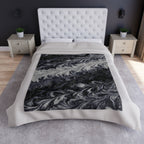 Bed with a marble-patterned comforter in a bedroom setting