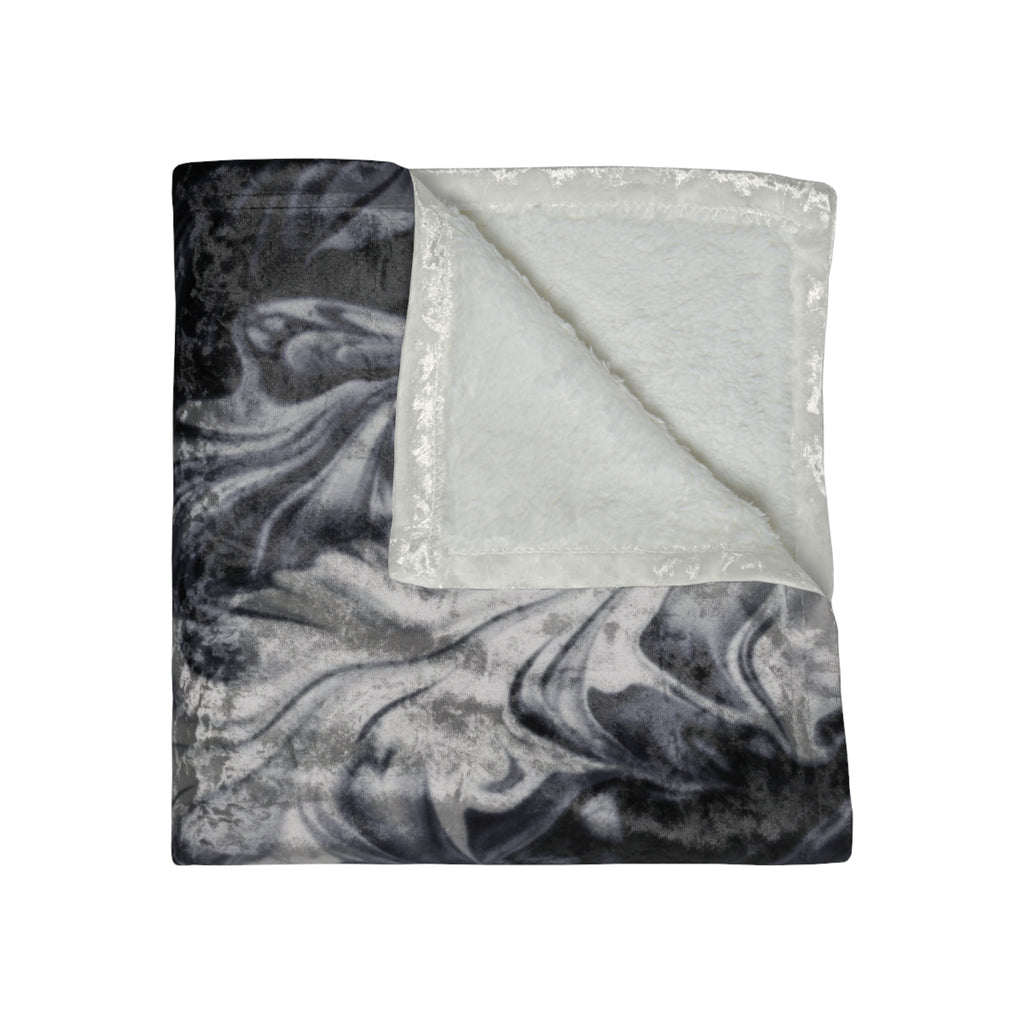 Marble-patterned blanket with a plain white fabric underneath on a white background