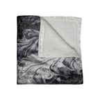 Marble-patterned blanket with a plain white fabric underneath on a white background