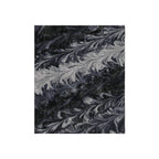 Marbled black and gray pattern blanket on a white background